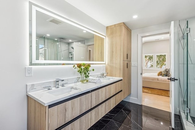 bathroom featuring vanity and an enclosed shower