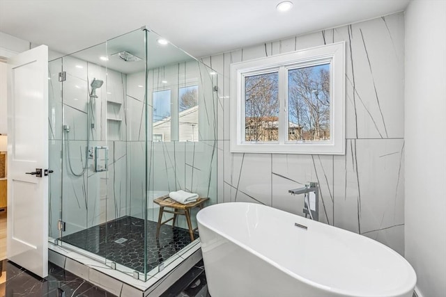 bathroom featuring shower with separate bathtub