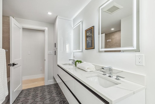 bathroom featuring tile patterned flooring and vanity