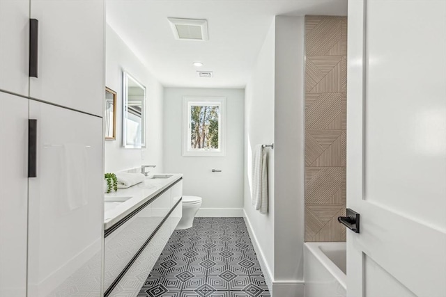 bathroom featuring vanity, tile patterned floors, and toilet