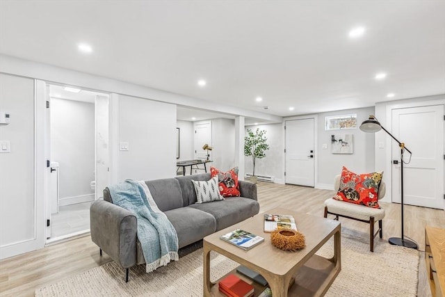 living room featuring a baseboard radiator and light wood-type flooring