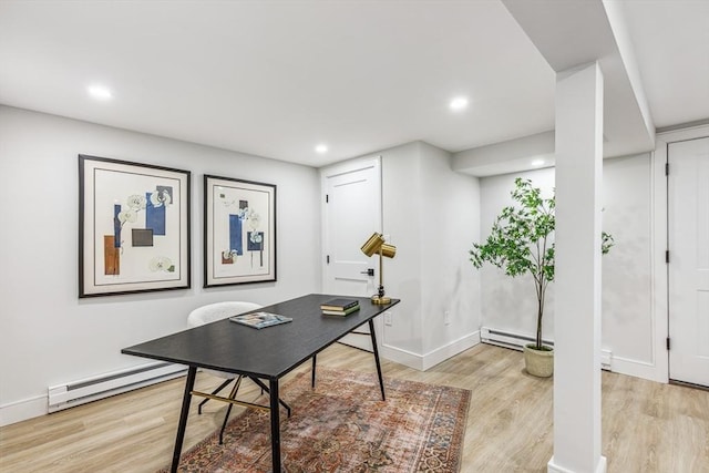 home office with light wood-type flooring and baseboard heating