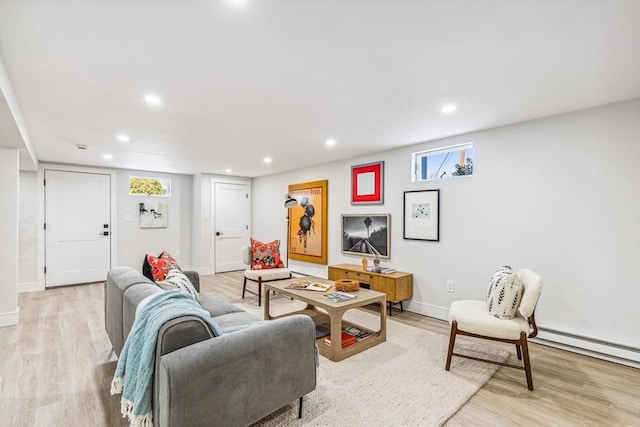 living room with baseboard heating and light wood-type flooring