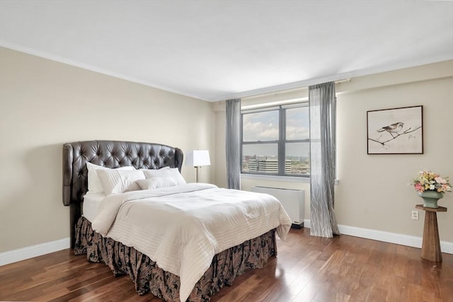 bedroom with radiator and dark hardwood / wood-style flooring