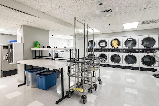 laundry room featuring stacked washer and dryer and washing machine and dryer