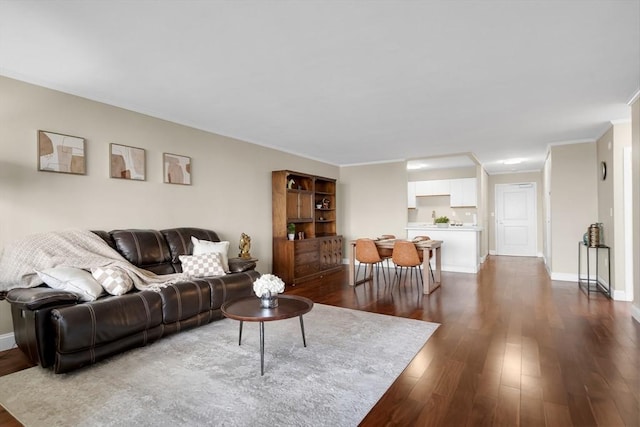 living room with crown molding and dark hardwood / wood-style floors