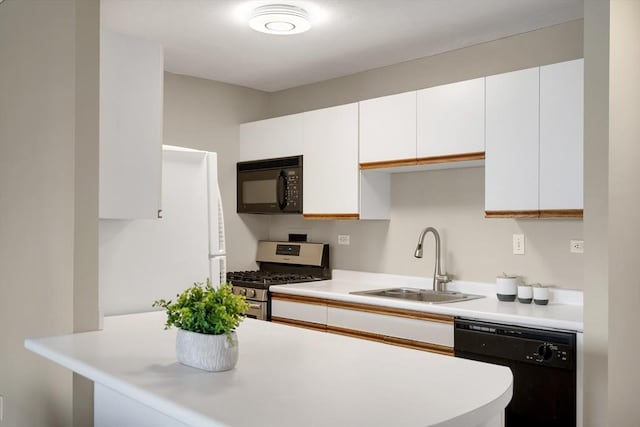 kitchen featuring black appliances, white cabinets, kitchen peninsula, and sink