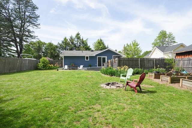 207 Belanger, Southampton, MA 01073 - rear view of house with a vegetable garden and an outdoor fire pit