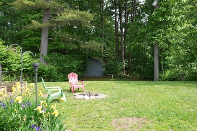 207 Belanger, Southampton, MA 01073 - view of grassy yard featuring an outdoor fire pit
