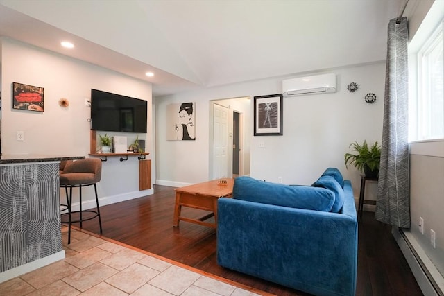207 Belanger, Southampton, MA 01073 - living room with a wall unit AC, recessed lighting, lofted ceiling, baseboards, and wood finished floors