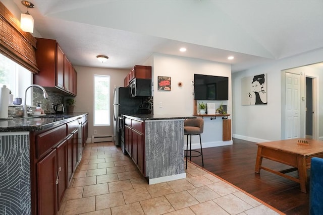 207 Belanger, Southampton, MA 01073 - kitchen with stainless steel microwave, a sink, a kitchen bar, light tile patterned flooring, and backsplash