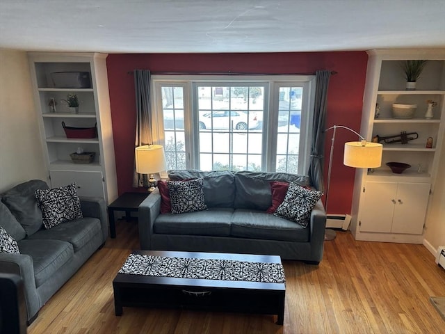 living room featuring light wood-style floors and a baseboard heating unit