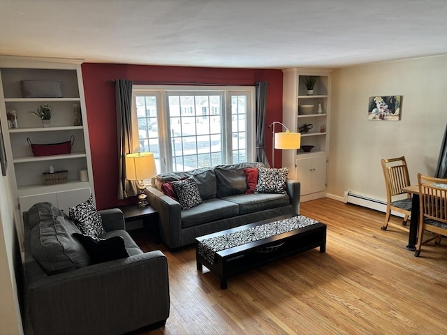 living room with a baseboard radiator, wood finished floors, and baseboards