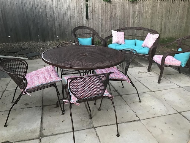 view of patio / terrace with outdoor dining area, outdoor lounge area, and fence