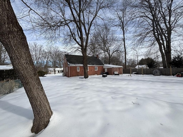 snowy yard with fence