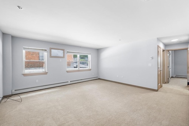 275 W Main St Unit 21, Marlborough, MA 01752 - empty room with baseboard heating, light carpet, a baseboard heating unit, and baseboards