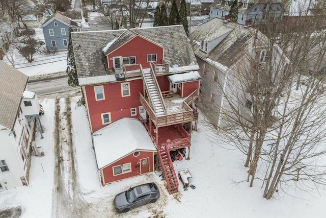 snowy aerial view with a residential view