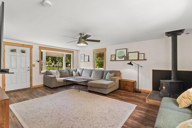 2025 S St, Bridgewater, MA 02324 - living room featuring a wood stove, ceiling fan, dark wood-style floors, and baseboards