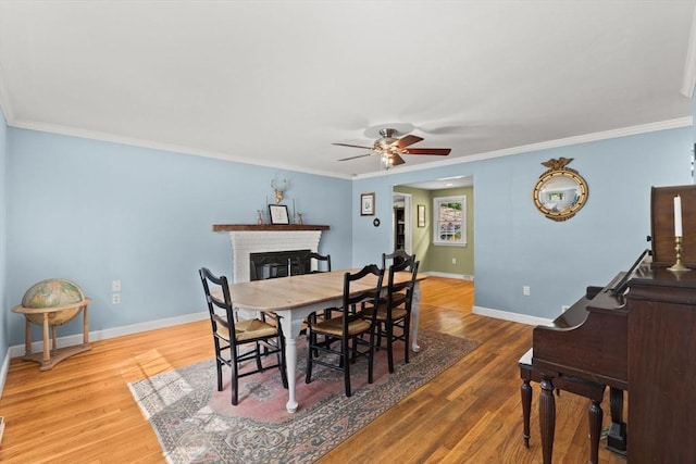 2025 S St, Bridgewater, MA 02324 - dining room with a ceiling fan, a fireplace, wood finished floors, ornamental molding, and baseboards