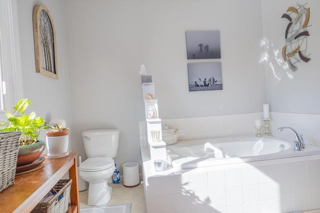 full bath with a garden tub, toilet, and tile patterned floors