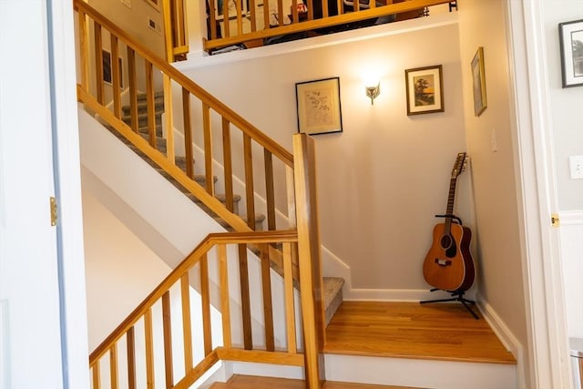 stairs featuring baseboards and wood finished floors