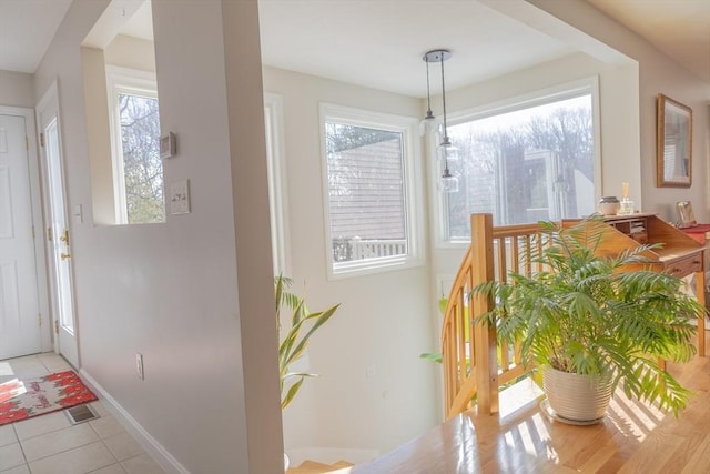 interior space featuring visible vents, baseboards, and light tile patterned floors