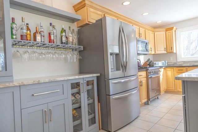 kitchen featuring recessed lighting, gray cabinetry, appliances with stainless steel finishes, glass insert cabinets, and light tile patterned flooring