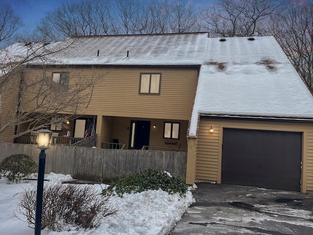 view of front of home with fence and driveway