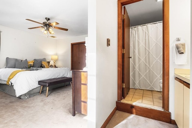 bedroom with light carpet and ceiling fan