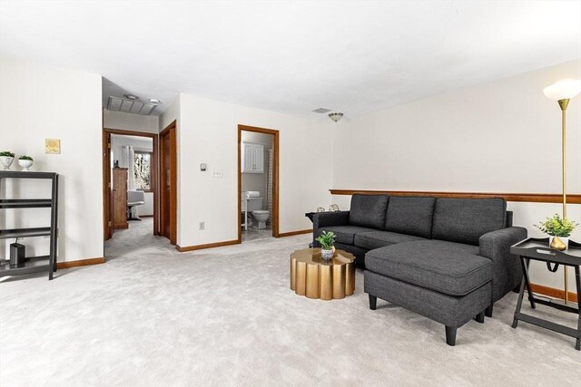 living room featuring light colored carpet, visible vents, and baseboards