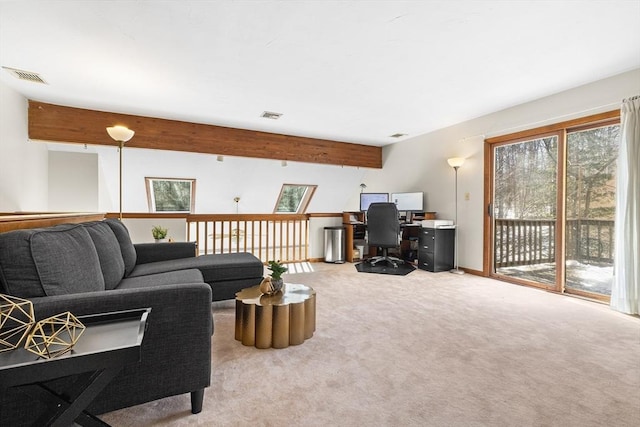 living room featuring light colored carpet, a healthy amount of sunlight, and visible vents