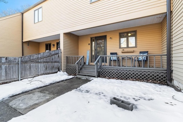 snow covered property entrance featuring a porch