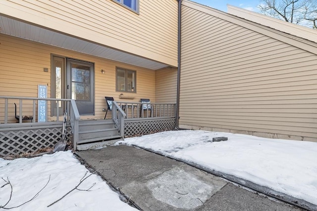 snow covered property entrance featuring covered porch