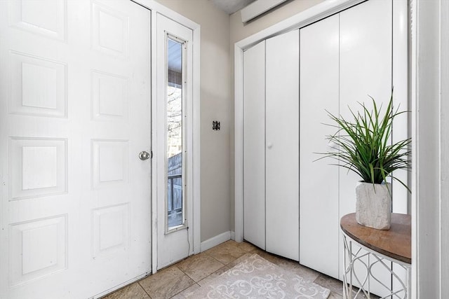 foyer entrance with light tile patterned floors