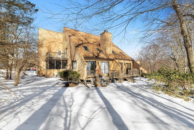 view of front of property with a chimney and a deck