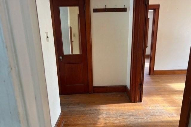 hallway with baseboards and wood finished floors