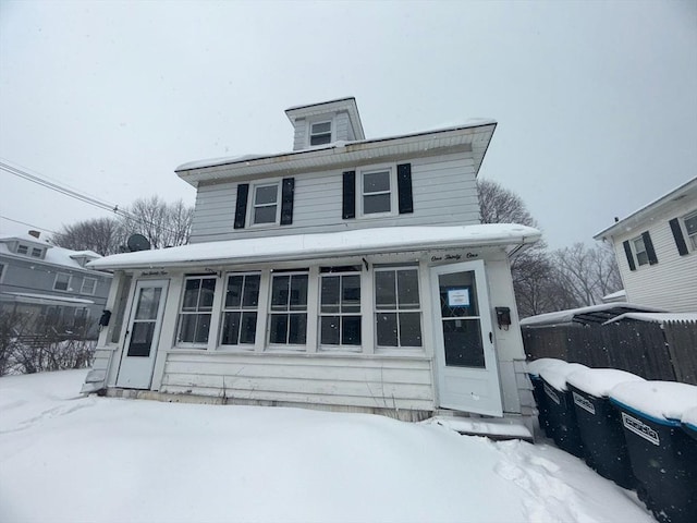 american foursquare style home featuring fence