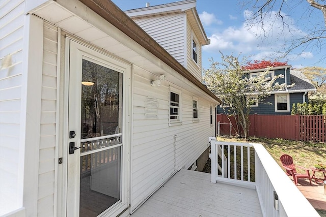 wooden terrace featuring fence