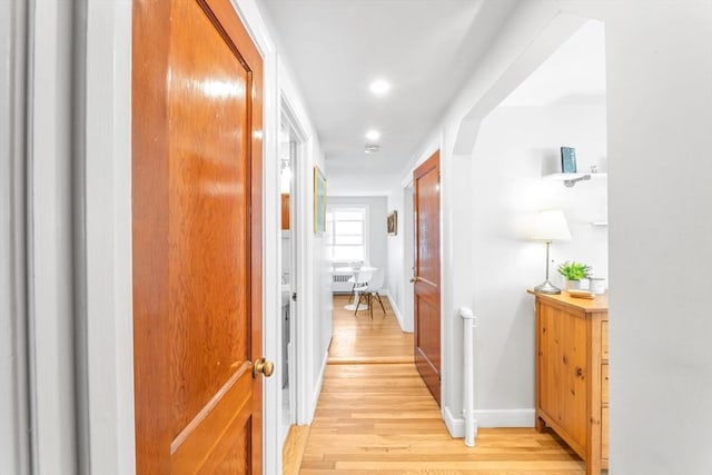 hallway with baseboards, recessed lighting, and light wood finished floors