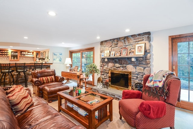 carpeted living room with a healthy amount of sunlight and a fireplace