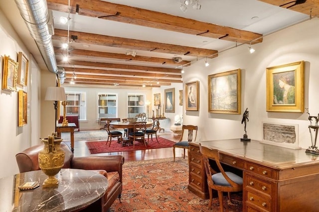 interior space with beamed ceiling and track lighting