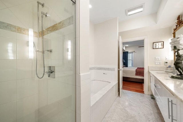 bathroom with vanity and separate shower and tub