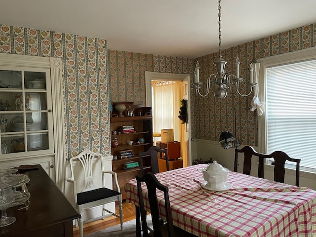 dining room featuring wood-type flooring and a notable chandelier