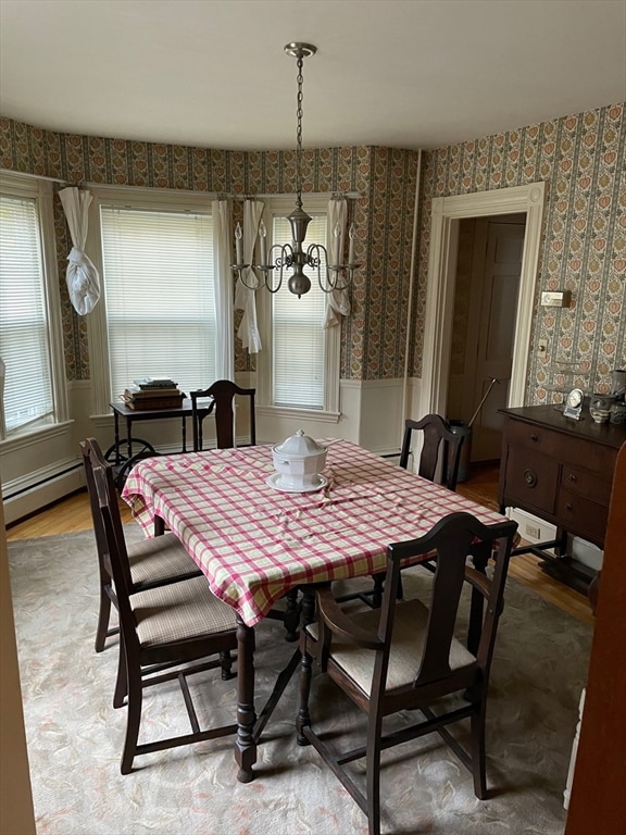 dining space with hardwood / wood-style flooring and a baseboard radiator