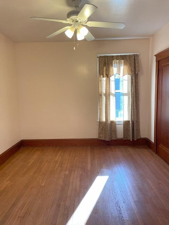 empty room featuring hardwood / wood-style floors and ceiling fan