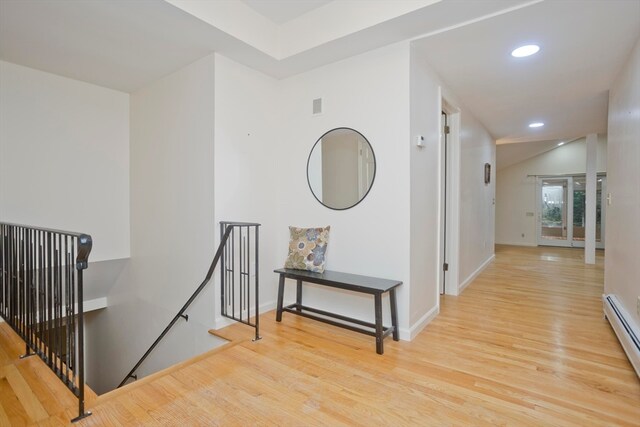 hall with a baseboard radiator and light wood-type flooring