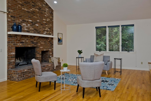 interior space featuring hardwood / wood-style floors, a fireplace, and vaulted ceiling