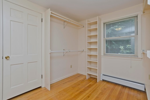 walk in closet with hardwood / wood-style floors and a baseboard radiator