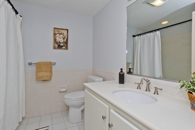 bathroom featuring a shower with shower curtain, toilet, tile patterned floors, tile walls, and vanity