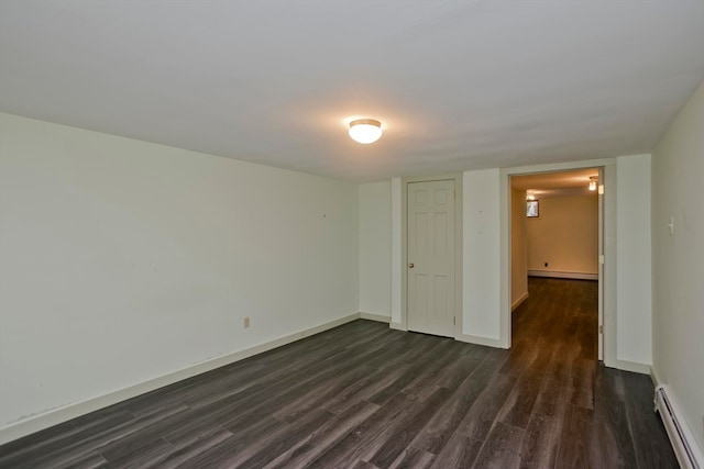 unfurnished bedroom featuring a baseboard radiator, dark hardwood / wood-style floors, and a closet